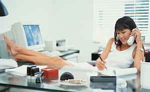 Woman Lounging at Office Desk ca. 2001